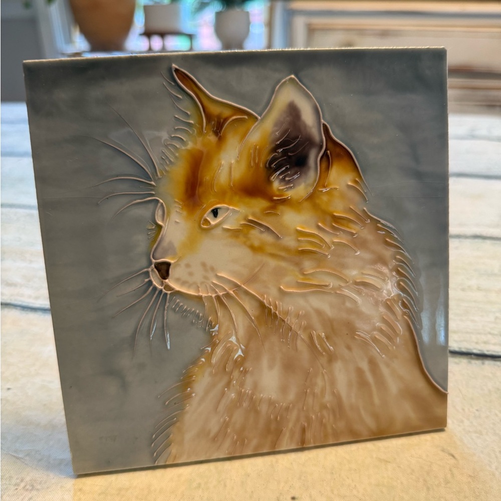 Ceramic tan cat tile art work.